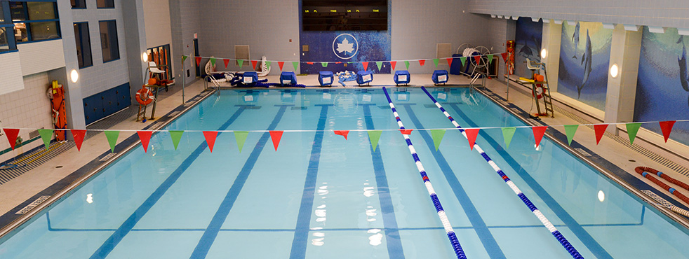 An empty indoor swimming pool in a recreation center.