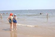 Two older women talking down by the water. 