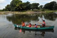 A ranger and children begin a ride around the lake 