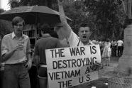 Vietnam War protester carrying sign: 