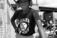 Boy with baseball helmet and bat, Harlem RBI's 