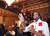 People gather to celebrate in the building before turning the lights on. 