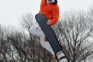 A talented snowboarder in the air. 