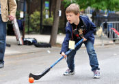 A boy playing street hockey. 