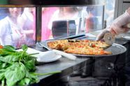 Preparing a pizza at Taste of Parks 2011 