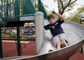 Taking the slide down Campanaro Playground 