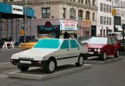 Imagine you are driving a red Volkswagen and Imagine you are driving a white Honda (2004), painted aluminum sculptures , view from front 