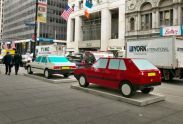 Imagine you are driving a red Volkswagen and Imagine you are driving a white Honda (2004), painted aluminum sculptures, view from rear 