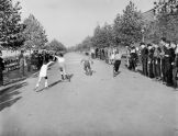 Boys compete in a rollerskating race on Riverside Drive 