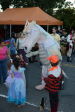 A dragon greets the kids, all costumed, at the fest. 