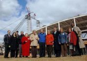 Officials pose at the topping-out ceremony. 